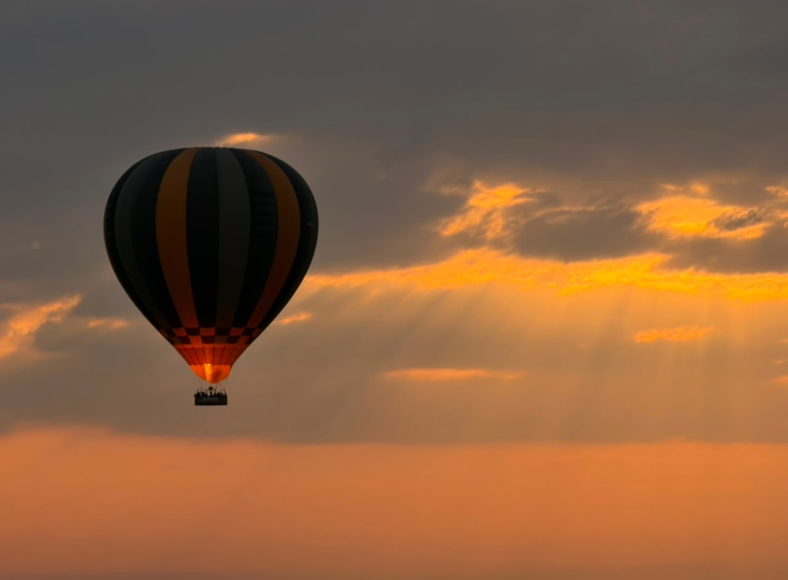 Hot-air balloon over Tanzania in golden light